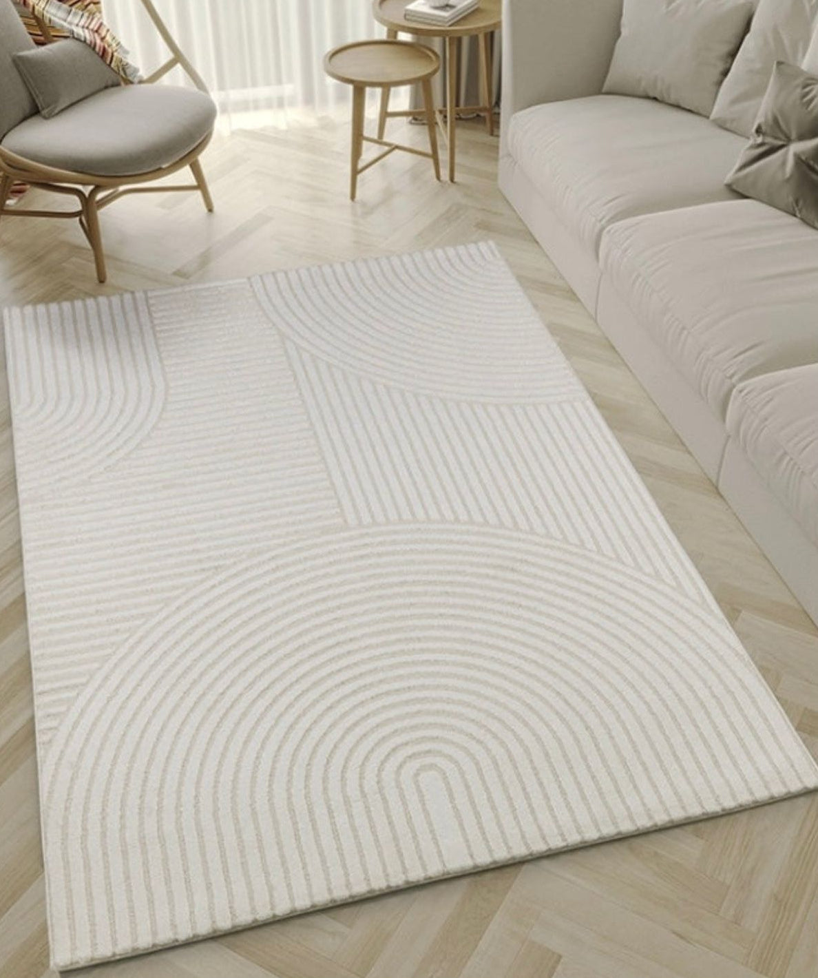 Tapis gris ELIO 52 avec motifs d'arches en relief dans un salon au style moderne organique et épuré.