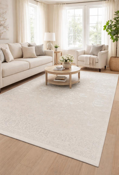 Mise en situation du tapis CREATION vintage crème dans un salon moderne avec canapé crème, montrant son rendu lumineux et élégant.