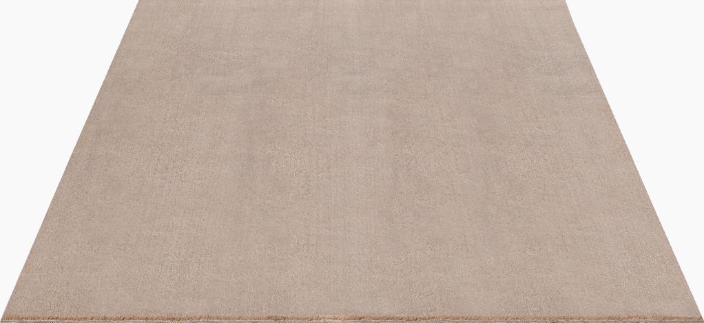 Gros plan sur les fibres denses du tapis LOFT beige foncé, texture shaggy moelleuse et lavable en machine.